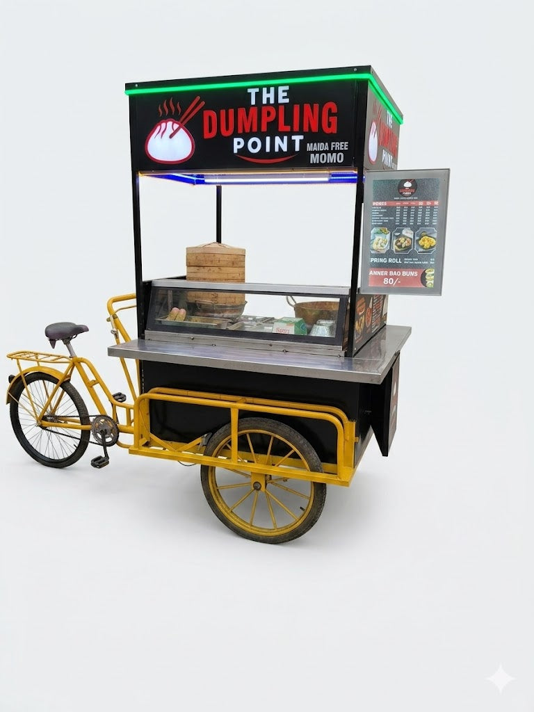 Yellow food cart with 'The Dumpling Point' branding on a white background